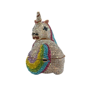 Detailed close-up of a unicorn clutch bag featuring sparkling rainbow gradient rhinestones