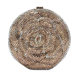 Macro detail of round evening clutch with multi-color floral rhinestone patterns