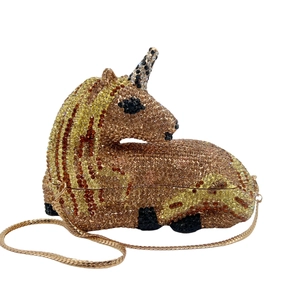 Detailed view of the sparkling crystal-encrusted unicorn clutch with gold chain strap