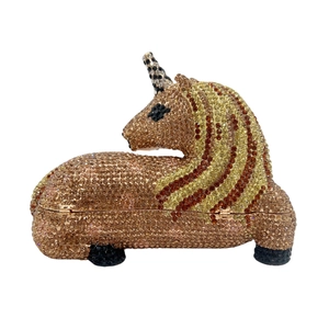 Detail of a luxury unicorn clutch bag with champagne and gold rhinestone crystals