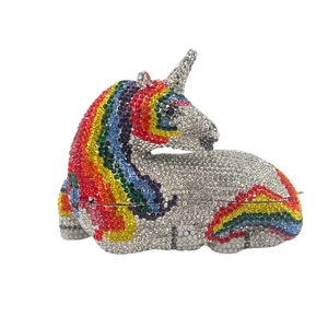 Macro shot of silver unicorn clutch featuring rainbow rhinestones on mane and tail