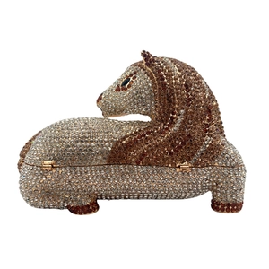 Macro shot of horse-shaped evening clutch with hand-set crystals and gold hinge details