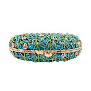 Elegant hollow metal clutch bag with colorful crystals and blue base for evening dress