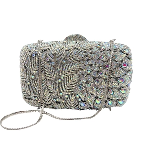 Close-up of luxury crystal clutch bag with silver rhinestones and peacock feather gems
