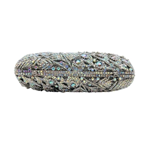 Detailed macro of oval crystal clutch bag featuring intricate leaf pattern rhinestone inlay