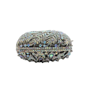 Macro detail of luxury evening clutch with colorful leaf pattern rhinestone inlay