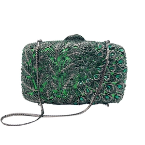 Detailed view of green crystal clutch featuring palm leaf pattern and dark nickel chain