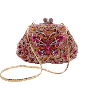 Macro detail of pink butterfly evening bag showing intricate rhinestones and gold chain