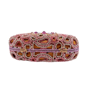 Macro detail of luxury butterfly evening clutch with pink and gold rhinestones
