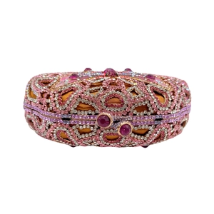 Close-up of luxury butterfly evening bag with pink and purple rhinestones on gold satin