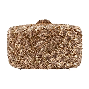 Detail shot of golden crystal clutch featuring intricate feather and peacock rhinestone patterns