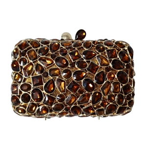 Luxury amber stone clutch bag with intricate crystal embellishments and gold metal frame