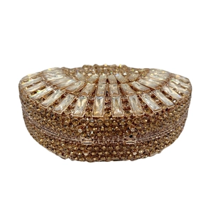 Detail of luxury hollow champagne gold evening clutch with sparkling crystals and metal frame