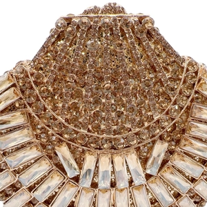 Macro shot of shell-shaped evening clutch with champagne crystals and golden rhinestones