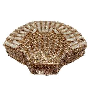 Detail of shell-shaped evening clutch with champagne gold crystals and metal frame