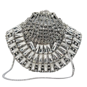 Close-up of silver fan-shaped hollow clutch bag with rectangle crystals and rhinestones