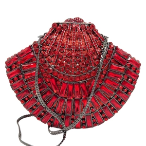 Close-up of red shell-shaped clutch bag with sparkling crystals and metal chain