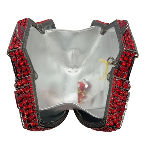 Detailed view of red crystal evening clutch interior with spare rhinestones and silver lining
