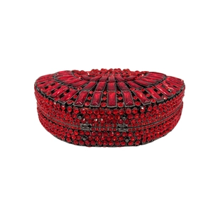Close-up of red crystals and rhinestones on luxury evening heart stone clutch bag