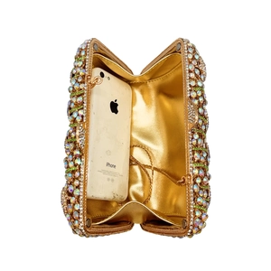 Golden rhinestone hollow evening clutch bag showing capacity to hold a mobile phone