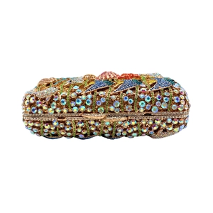 Macro view of crystal rhinestones on a luxury hard-shell ocean-themed evening clutch bag