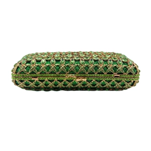 Vintage gold hollow evening clutch with green floral rhinestone pattern on white background
