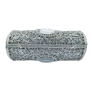 Silver cylindrical clutch bag with hollow metal pattern and sparkling rhinestones