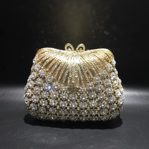 Elegant rhinestone evening clutch bag with gold metal frame and sparkling bow clasp