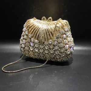 Elegant gold rhinestone evening clutch bag with shell pattern and crystal bow clasp