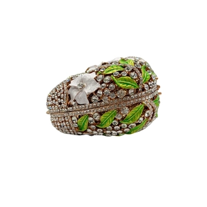 Exquisite floral enamel egg jewelry box with sparkling crystals and white embossed flowers