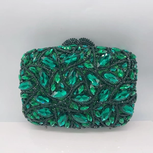 Macro shot of luxury green crystal clutch featuring large emerald-tone marquise rhinestones