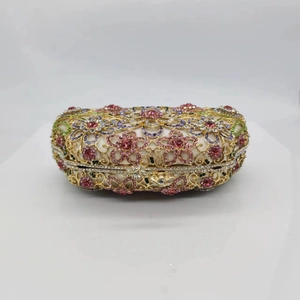 Close-up of luxury floral evening bag featuring pink and purple crystal embellishments
