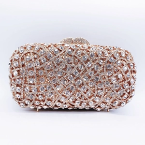 Close-up of luxury crystal clutch bag featuring hand-set rhinestones and gold metal frame