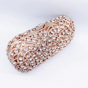Luxury gold capsule clutch bag with shimmering crystals and intricate rhinestone design