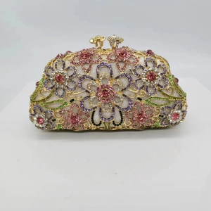 Detailed close-up of colorful crystal flower patterns on luxury evening clutch bag