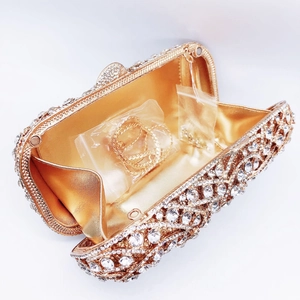 Luxury gold evening clutch bag with wave-patterned crystals and dual chain straps