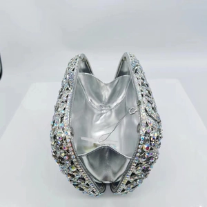 Elegant hollow metal clutch bag with sparkling colorful crystals and silver lining interior
