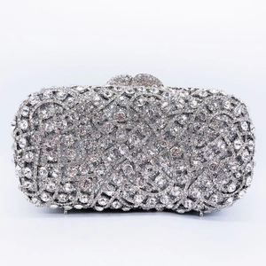 Detail of luxury silver evening clutch bag featuring full crystal rhinestone encrustation