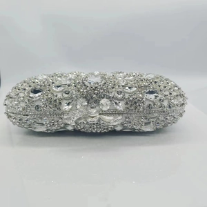 Macro view of crystal encrusted evening clutch bag with luxury diamond patterns