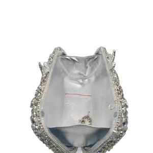 Internal view of silver rhinestone evening bag with shiny metallic lining and spare stones