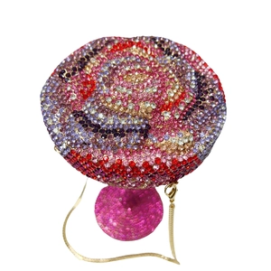 Detail of mushroom clutch bag featuring gradient rhinestones and gold snake chain