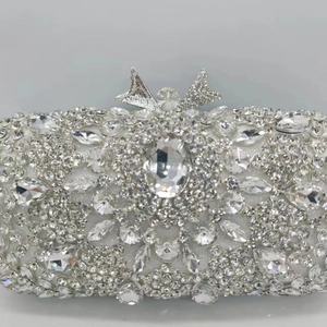 Elegant silver evening clutch bag with full rhinestone embellishment and bow metal clasp