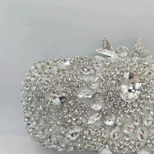 Sparkling crystal evening clutch bag with ornate snowflake patterns and a bow clasp