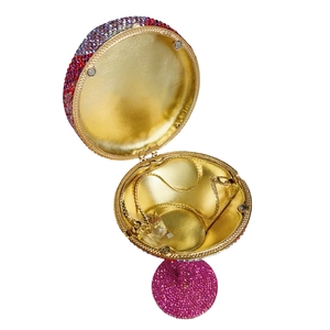 Detailed top view of open round clutch bag with gradient pink rhinestones and gold chain