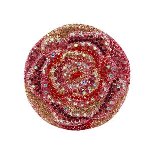 Detailed top view of a circular evening clutch bag with red crystal rose floral patterns