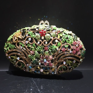 Macro view of crystal evening clutch bag with colorful rhinestones and hollow floral metal