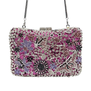 Detailed view of hollow floral crystal clutch with butterfly and silver chain strap