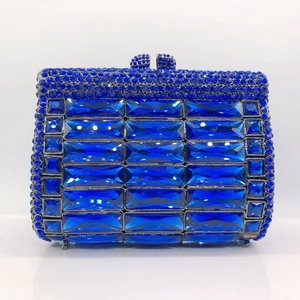 Detail of dark blue evening clutch bag with rectangular crystals and rhinestone lock