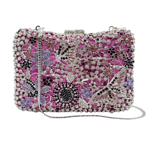Detail of rose red crystal clutch bag with hollow flower and diamond butterfly patterns