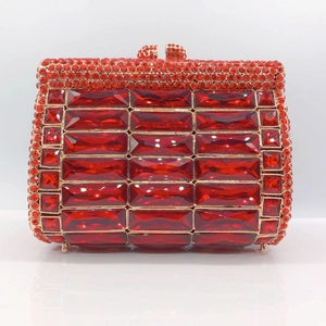 Macro shot of luxury red crystal evening clutch bag with gold-tone metal frame and clasp